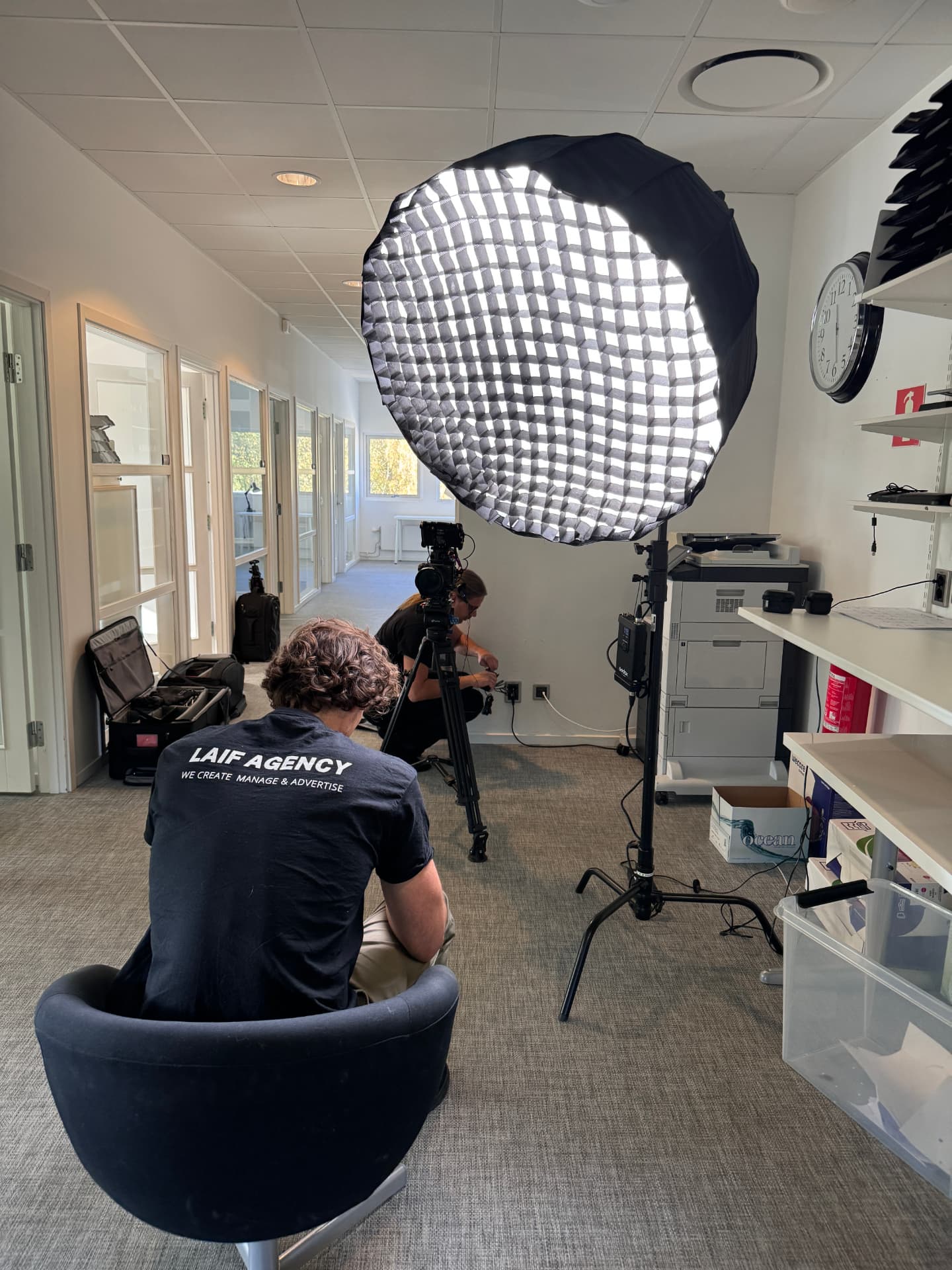 Preparing lighting and camera equipment for a shoot